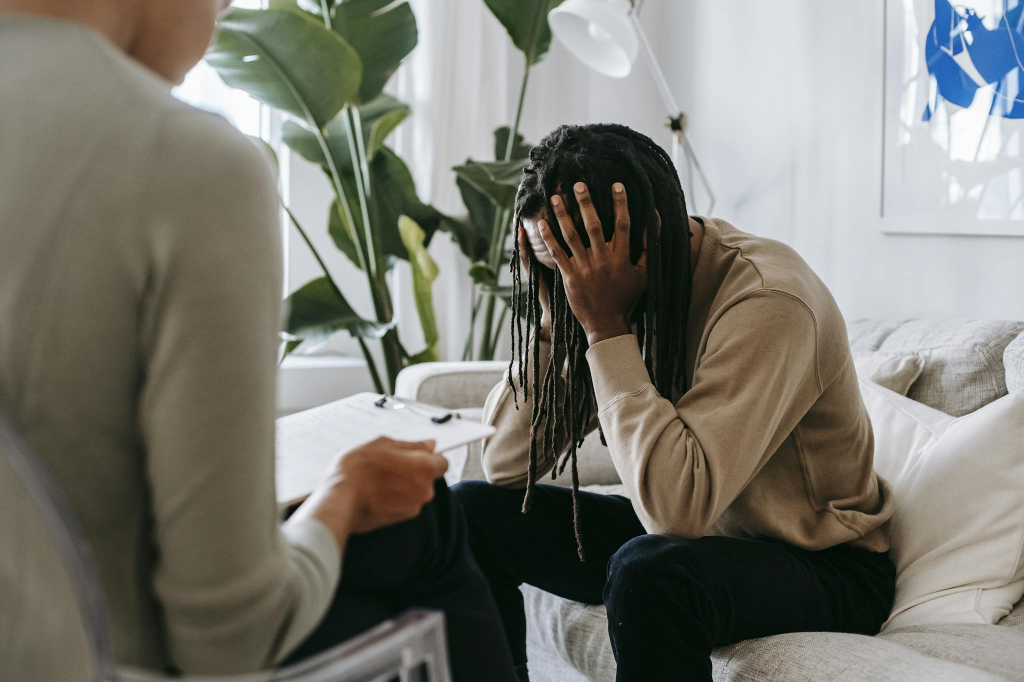 A concerned client in therapy, seeking professional support and guidance indoors.